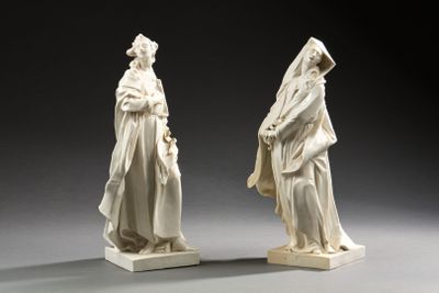 une paire de statues blanches représentant une femme et un homme portant un voile sur la tête