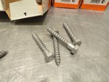 three screws that are sitting on a table