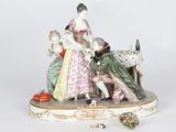 a figurine of a woman and two children sitting on a bench