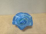 a blue glass bowl sitting on top of a wooden table