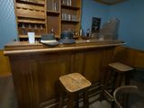 a wooden bar with two stools in front of it
