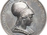 une image représentant une médaille d'argent sur laquelle figure la tête d'une femme