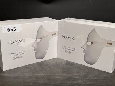 two boxes of noodance products on a table with a clock in the background