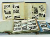 an open book sitting on top of a white table next to a pile of pictures
