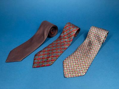three different colored ties on a blue background with a blue background