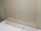 a glass shelf with a mirror on top of it