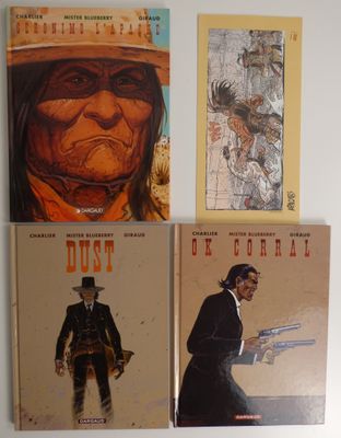 trois livres posés contre le mur d'une pièce, sur lesquels figurent des images