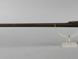 an old gun on a stand with a key in it