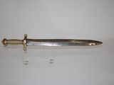 a close up of a knife on a stand on a white surface
