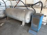 a large tank and a blue machine in a room