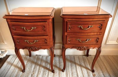 two wooden nightstands sitting next to each other on the floor