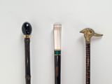 three different types of walking canes on a white surface