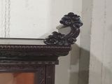 a clock that is sitting on top of a cabinet