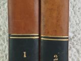 two old books sitting on top of a table next to each other