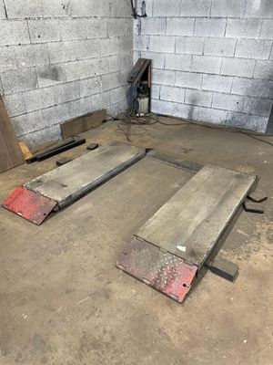 two pieces of metal sitting on the floor in a room