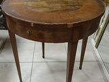 a small table with a wooden top on a tile floor