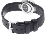 wrist watch with black leather strap on white background on white surface