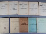 several books are lined up on a table with a blue background