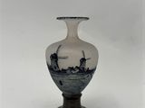 a white vase with a blue and white design on it