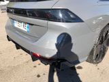 a shadow of a person standing in front of a car