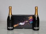two bottles of champagne sitting next to each other on a table