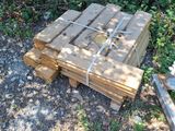 a pile of wood sitting on the ground in the yard