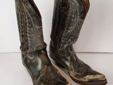 pair of brown cowboy boots on a white surface