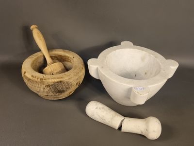 mortar and mortar set on a table with a wooden spoon