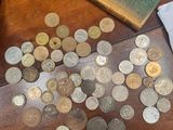 a lot of coins on the table next to a camera