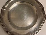 a silver plate on a table with a white table cloth