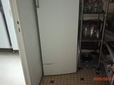 a refrigerator in the corner of a kitchen next to a counter
