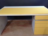 a yellow and white desk with three drawers