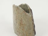 a close up of a stone object on a white surface