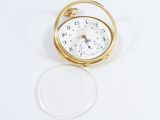 a small gold pocket watch sitting on a white surface