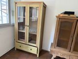 a wooden cabinet with a glass door and a wooden cabinet with a glass door