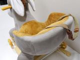 a stuffed animal that is sitting on a rocking horse