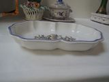 a white table with a blue and white bowl on it