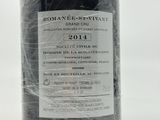 a bottle of wine that is wrapped in plastic