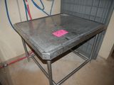 a metal table with a pink sticker on it