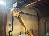 a crane that is sitting in a room with a light
