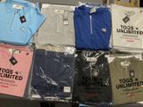a lot of t - shirts that are sitting on a table