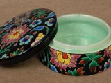 an image of a black and green box with flowers on it