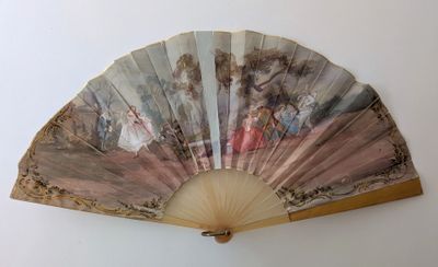 un ventilateur avec un tableau accroché au mur