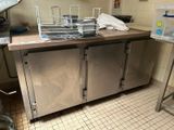 a kitchen with a sink and a counter with a lot of pots and pans on it