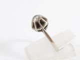 silver ring with a flower on top of a piece of clear quartz