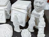 a lot of white ceramic figurines that are on a table