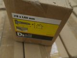 a box with a screw on it sitting on a wooden floor