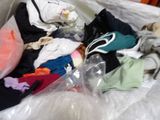 a pile of clothes in a plastic bag on the floor