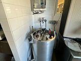 an image of a kitchen with a water heater in the corner