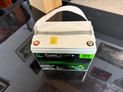 a box of batteries sitting on top of a glass table